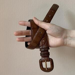 Valerie Steven’s brown leather belt with alligator print design